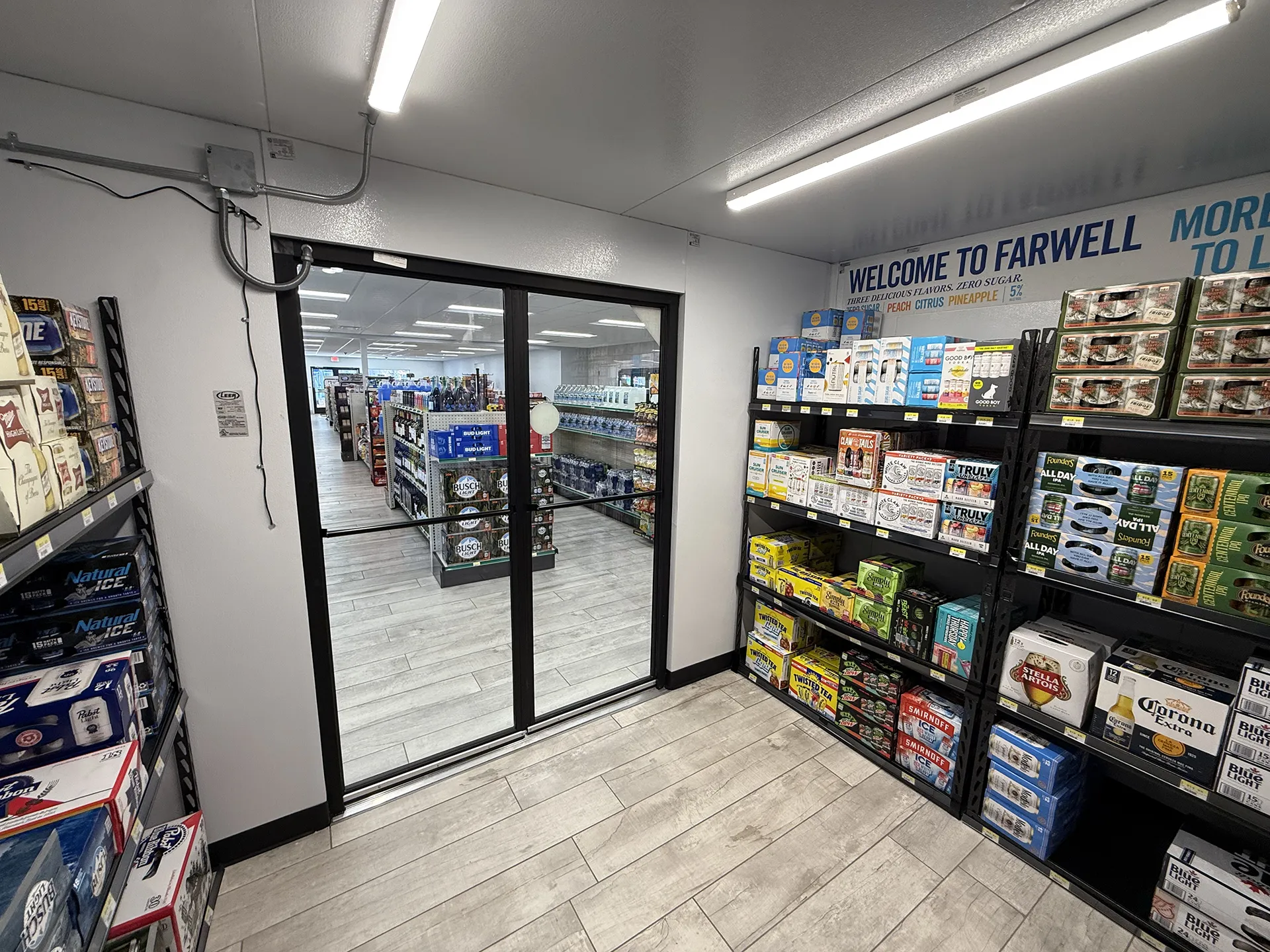 mart_project4 Walk-in beer cooler with glass entrance and stocked beverage shelves